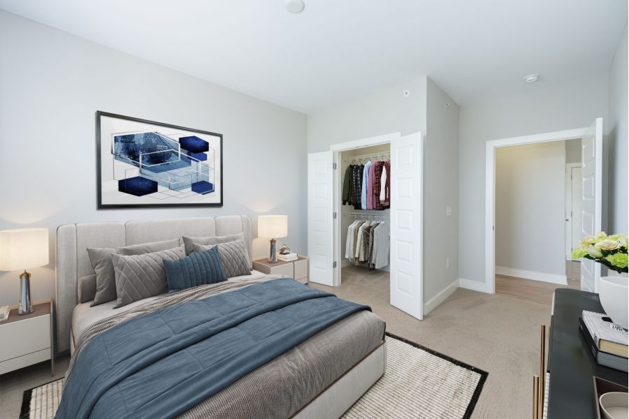 Infinity apartment homes with Modern bedroom with a neatly made bed, open closet, artwork above the bed, and neutral decor.